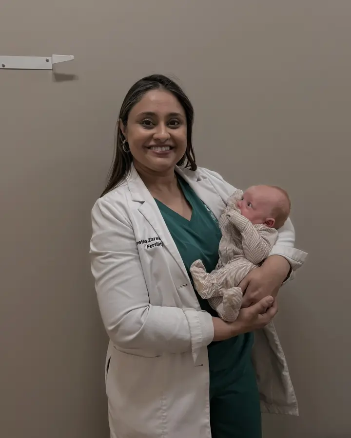 Dr. Zarek holding baby Bowen at Arbor Fertility