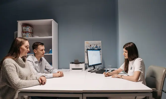 A couple consulting with a fertility specialist at a clinic