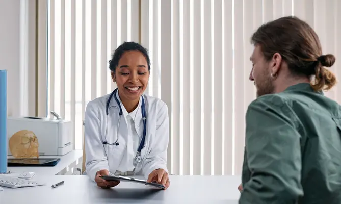 A doctor reviewing treatment plans with a patient during a fertility consultation