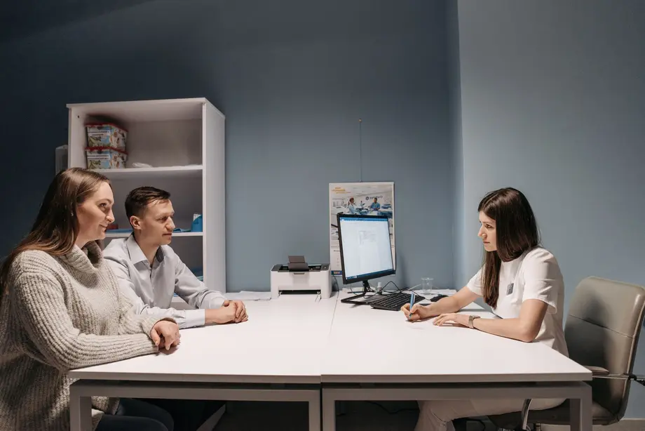 A couple consulting with a fertility specialist at a clinic