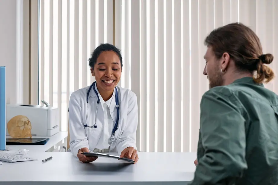 A doctor reviewing treatment plans with a patient during a fertility consultation