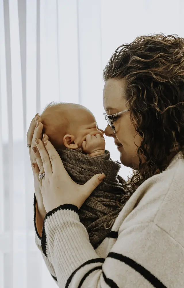 Crysten nose to nose with her newborn son Bowen, Arbor Fertility patients