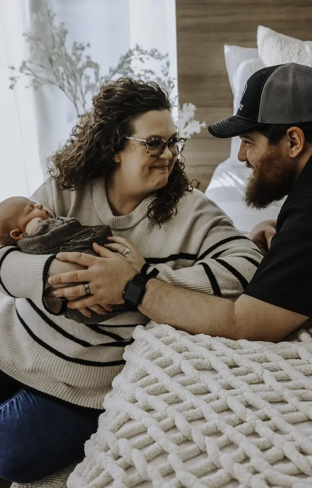 Crysten and her husband cuddling their newborn son Bowen, Arbor Fertility patients