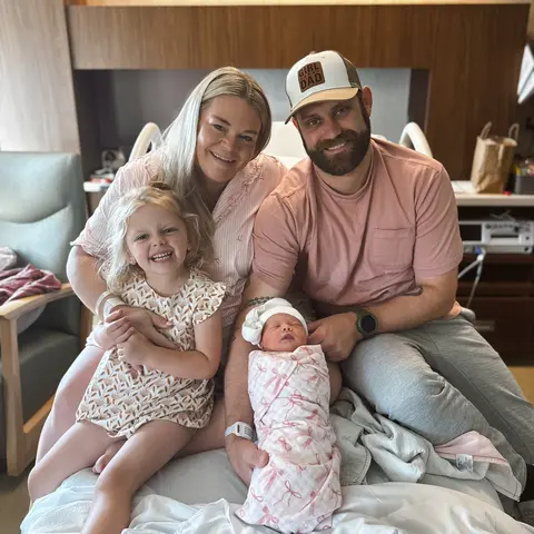 Brittany M. and her husband in the hospital with their young daughter and newborn baby girl