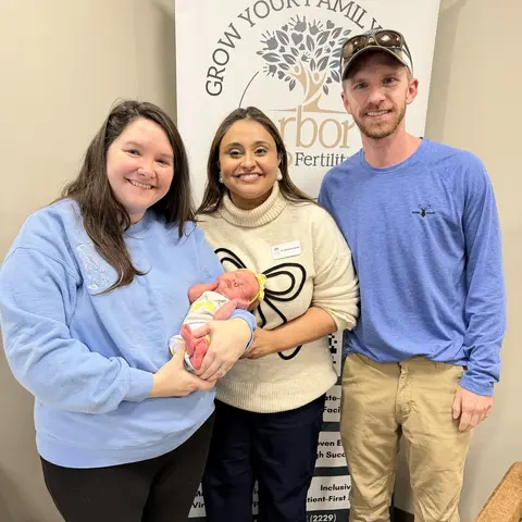 Regan V. and her husband with Dr. Zarek, who is holding their newborn daughter, at Arbor Fertility